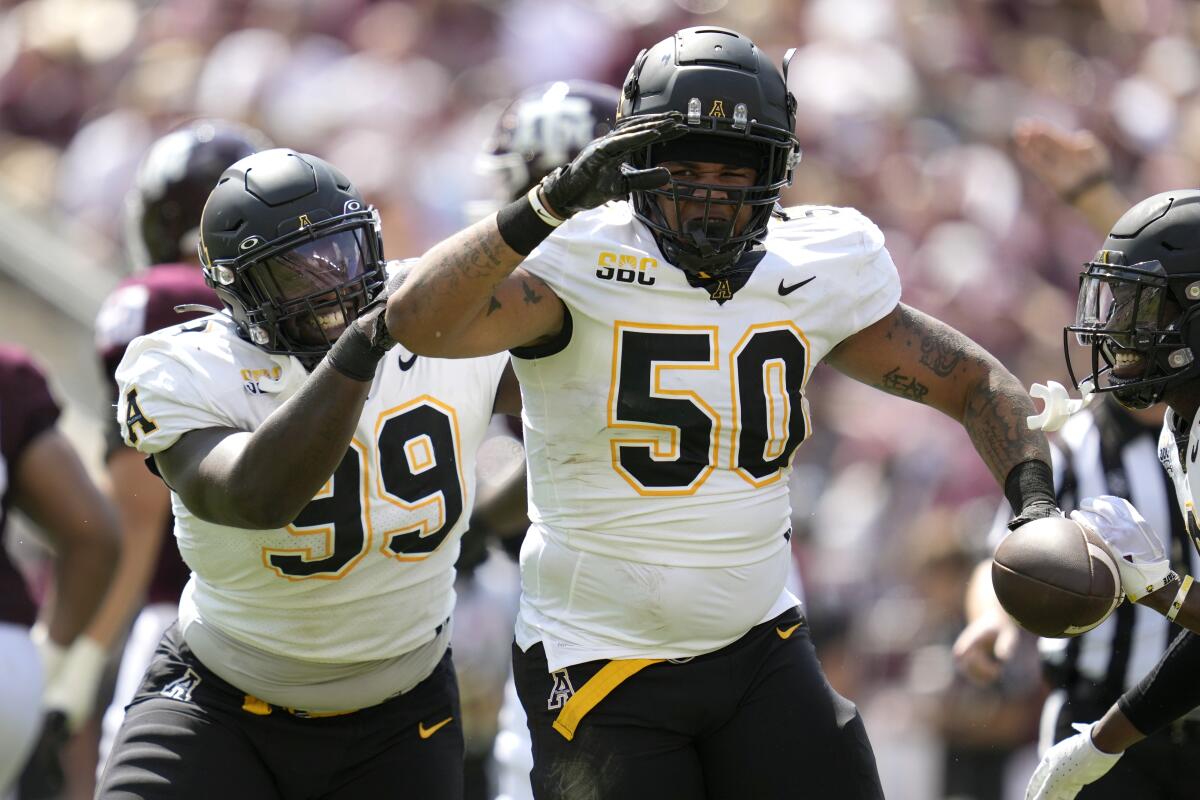 Appalachian State's DeAndre Dingle-Prince (50) and Jordon Earle (99) react after recovering a fumble Sept. 10, 2022.