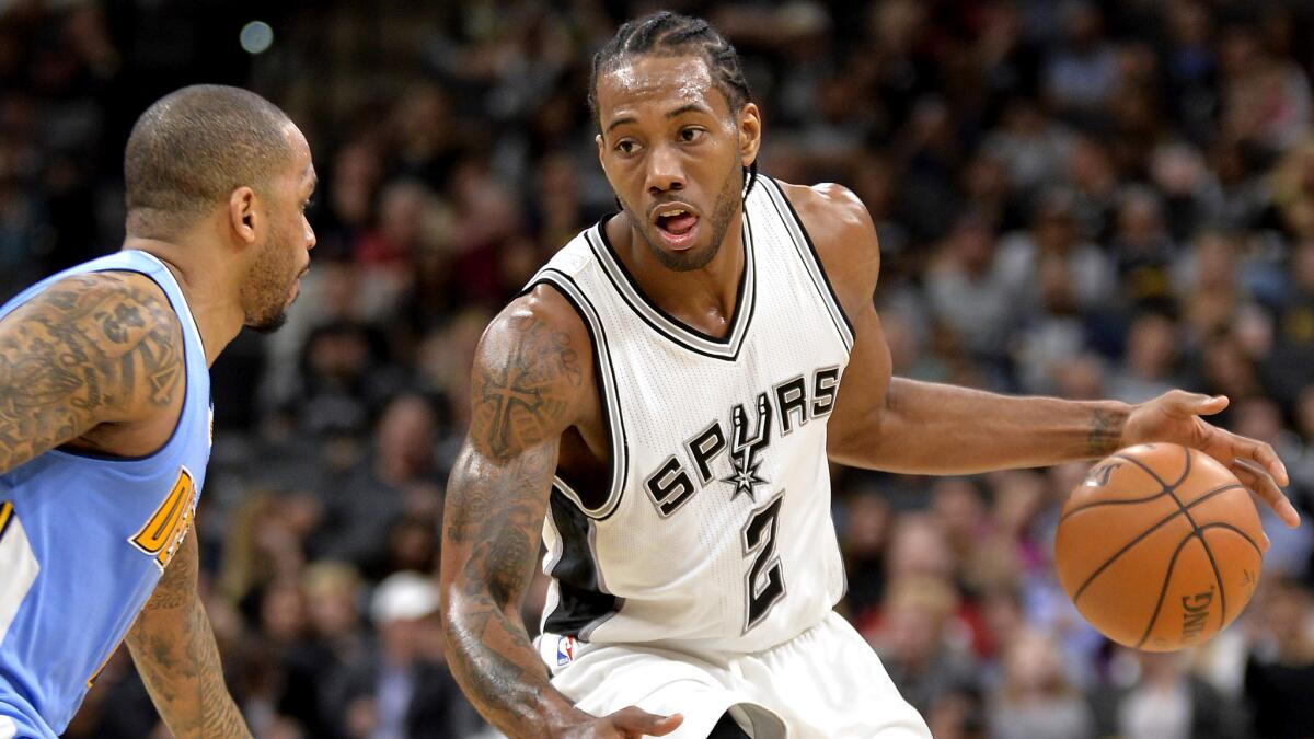 Spurs forward Kawhi Leonard (2) drives the lane against Nuggets guard Jameer Nelson during the second half Thursday.
