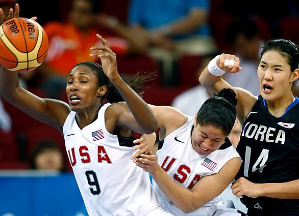 U.S. women's basketball players Lisa Leslie, left, and Kara Lawless, take the ball from Korea's Kweryong Kim during a lopsided victory for the Americans in the quarterfinal match at Beijing's Olympic Basketball Gymnasium. The U.S. won 104-60.