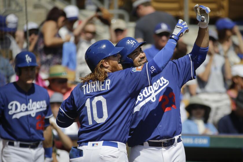 Dodgers third baseman Justin Turner (10) celebrates his home run with Adrian Gonzalez during the first inning of a spring training game against the Mariners.
