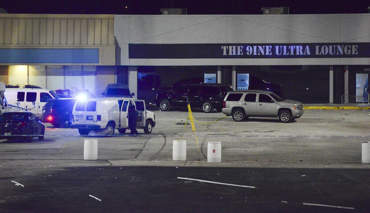 Kansas City, Mo., police crime scene investigators gather evidence early Monday at the scene of a shooting at a nightclub.