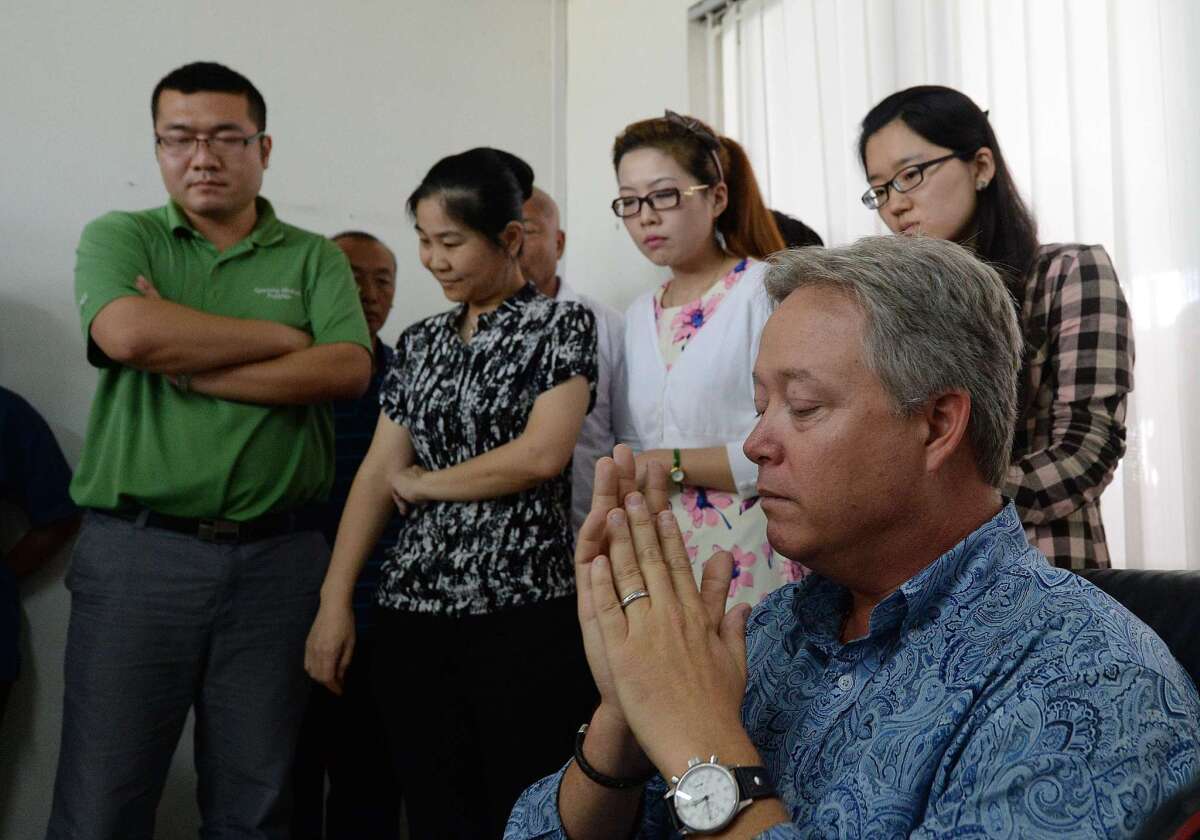 U.S. businessman Chip Starnes, right, who has been held hostage at his Chinese business for six days over a wage dispute, was released by his workers Thursday.