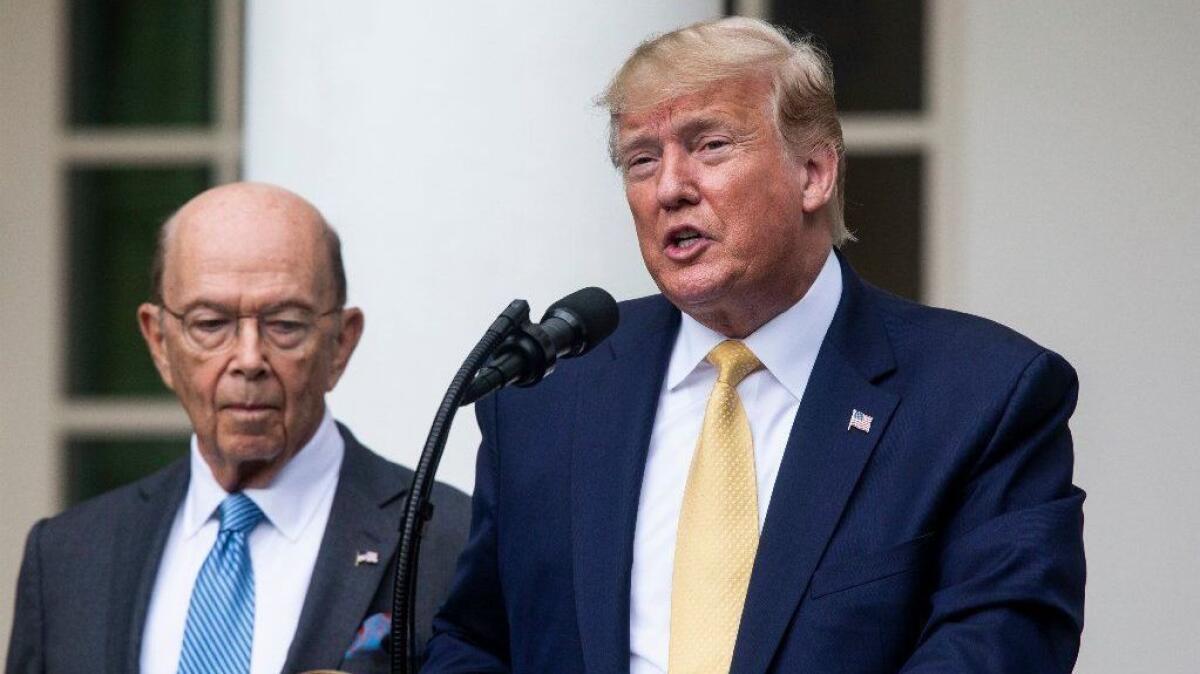 Commerce Secretary Wilbur Ross listens as President Trump speaks about citizenship and the U.S. census at the White House on Thursday.