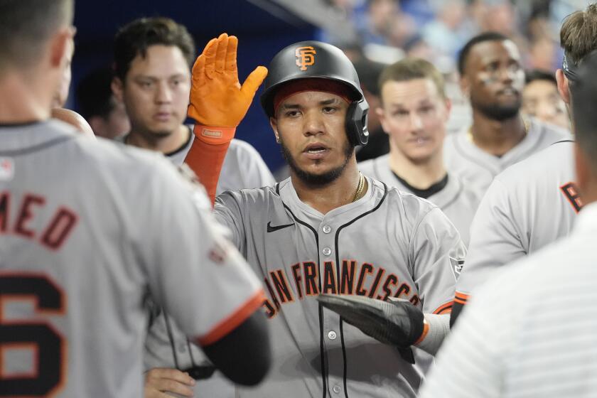 San Francisco Giants' Thairo Estrada scores in the seventh inning of a baseball game against the Miami Marlins, Wednesday, April 17, 2024, in Miami. (AP Photo/Marta Lavandier)