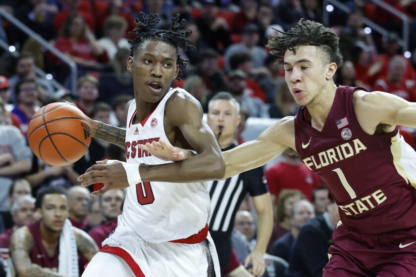 North Carolina State's Terquavion Smith (0) drives by Florida State's Jalen Warley (1) during the first half of an NCAA college basketball game, Wednesday, Feb. 1, 2023 in Raleigh, N.C. (Ethan Hyman/The News & Observer via AP)
