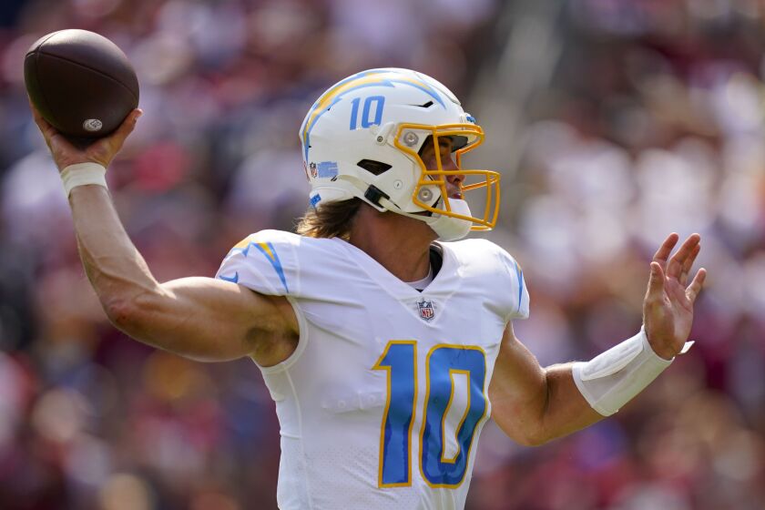 Los Angeles Chargers quarterback Justin Herbert (10) throws the ball against the Washington Football Team during the first half of an NFL football game, Sunday, Sept. 12, 2021, in Landover, Md. (AP Photo/Al Drago)