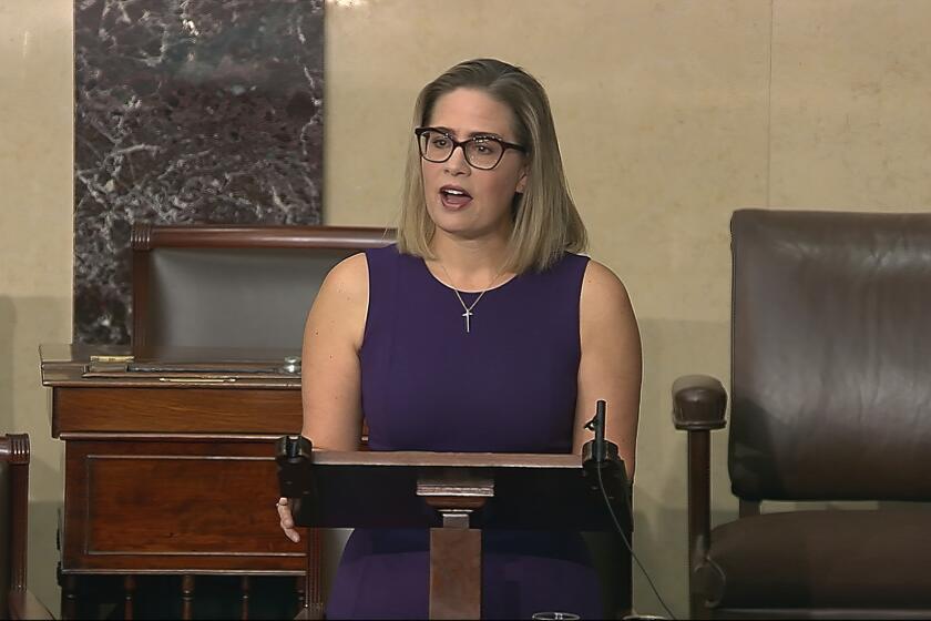 In this image from Senate Television, Sen. Kyrsten Sinema, D-Ariz., speaks on the floor of the U.S. Senate on Thursday, Jan. 13, 2022. President Joe Biden is set to meet privately with Senate Democrats at the Capitol, a visit intended to deliver a jolt to the party’s long-stalled voting and elections legislation. Before he arrived Sinema blunted the bill’s chances further, declaring she could not support a “short sighted” rules change to get past a Republican blockade. (Senate Television via AP)