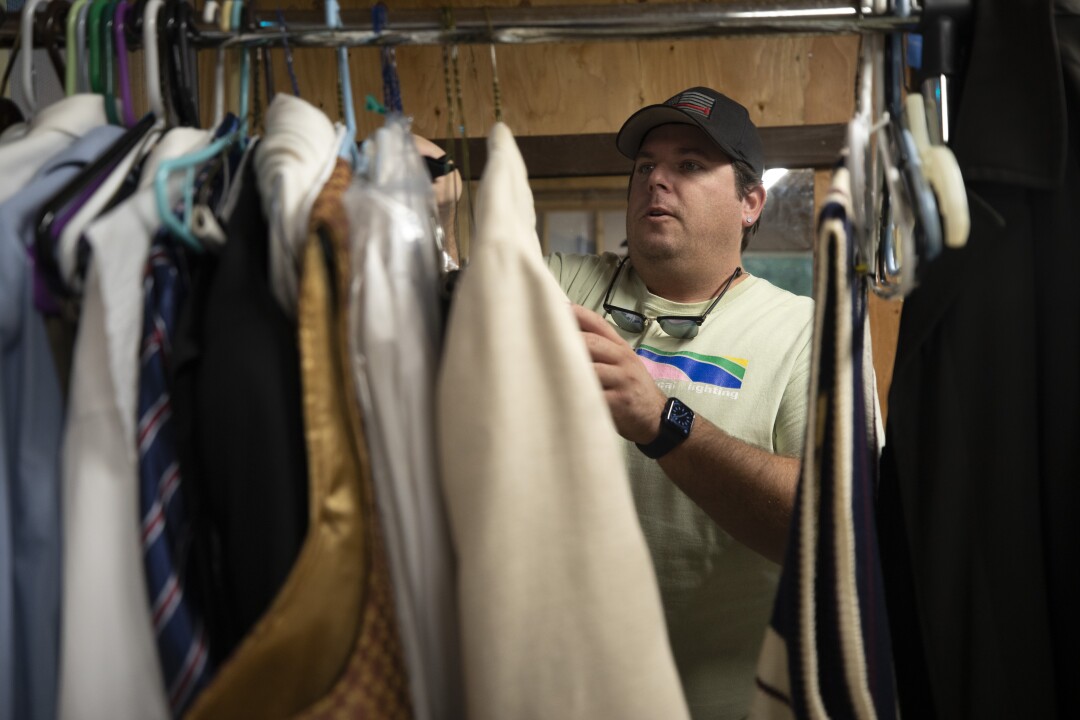 Actor Alex Sharp arranges his costumes