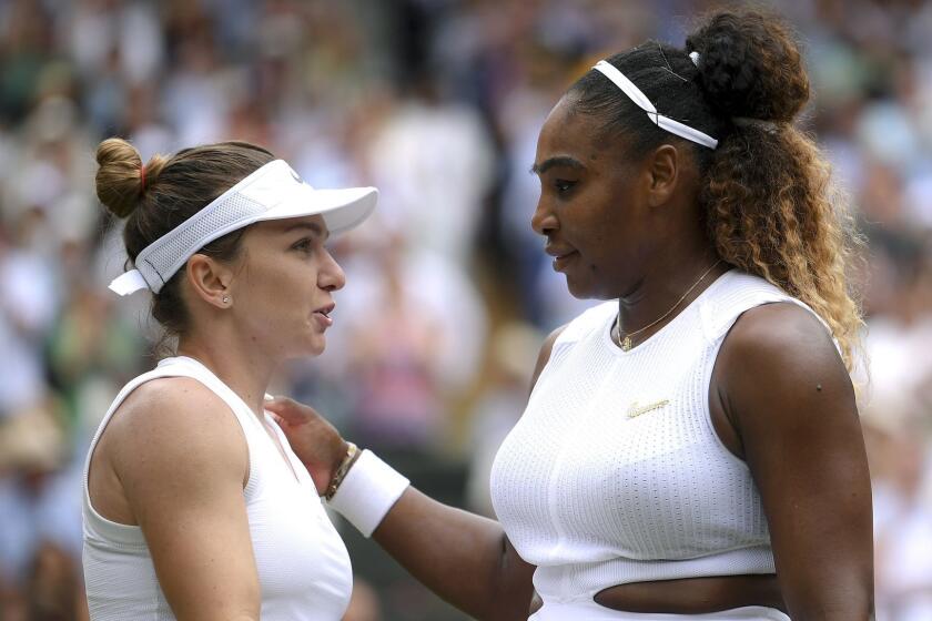 Romania's Simona Halep hugs United States' Serena Williams after defeating her in the women's singles final match on day twelve of the Wimbledon Tennis Championships in London, Saturday, July 13, 2019.(Laurence Griffiths/Pool Photo via AP)