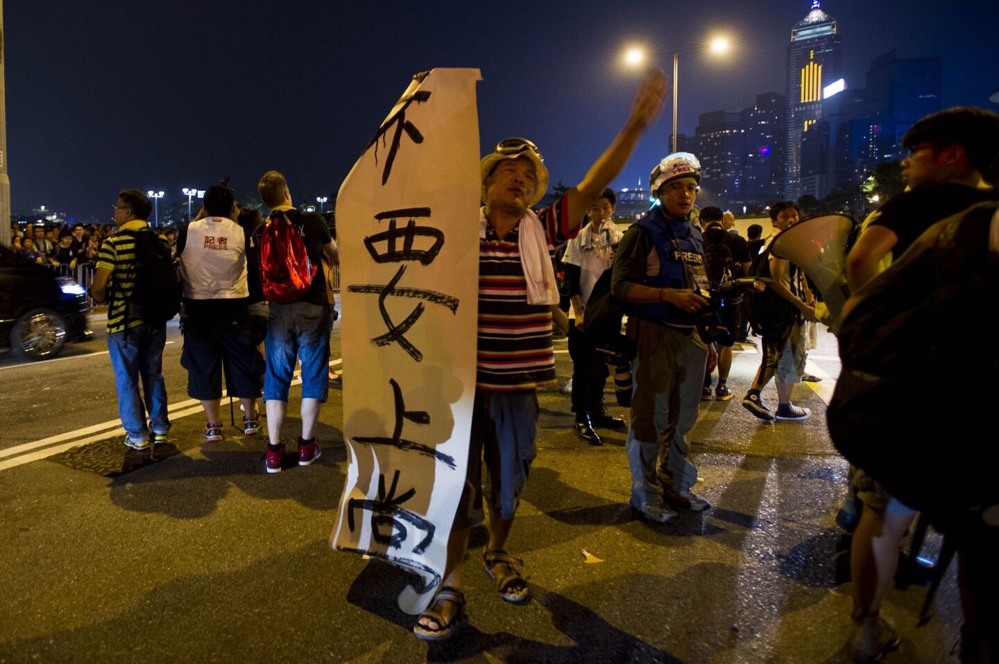 A man holds a sign that reads "Don't go to school" as a pro-democracy rally continues in Hong Kong.