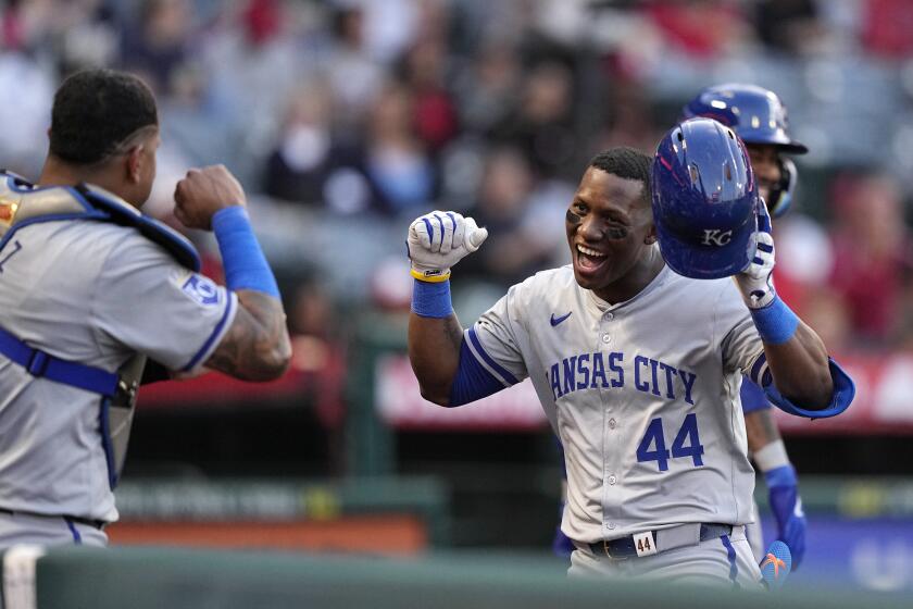 Kansas City Royals' Dairon Blanco, right, is congratulated by Salvador Perez after hitting a two-run home run during the third inning of a baseball game against the Los Angeles Angels Thursday, May 9, 2024, in Anaheim, Calif. (AP Photo/Mark J. Terrill)
