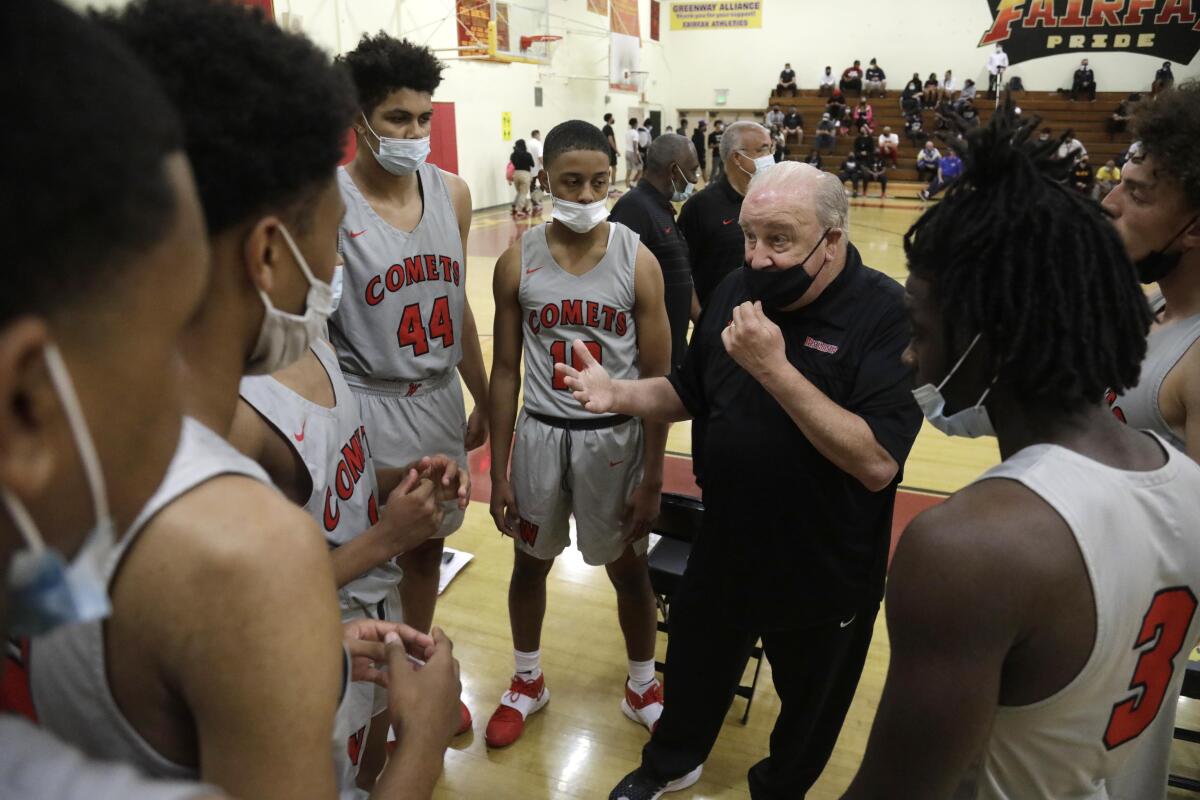 Coach Ed Azzam huddles with his Westchester players during a victory over Fairfax.