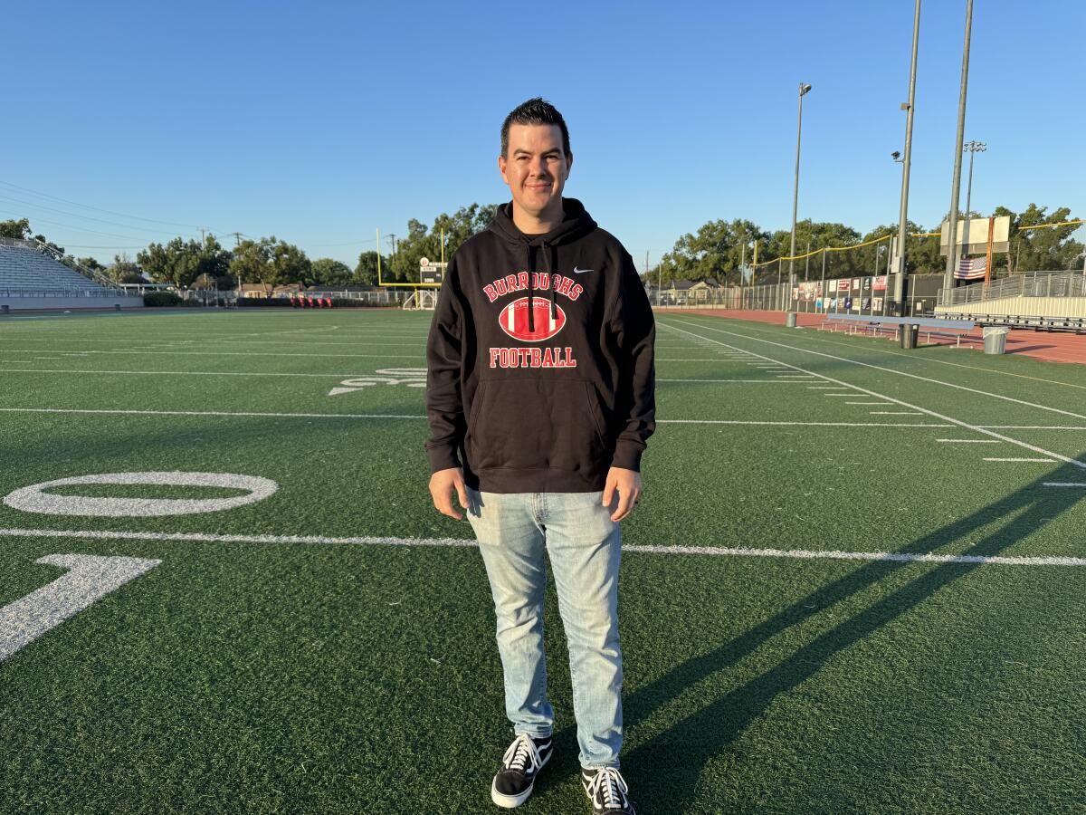 Burroughs High football coach Jesse Craven poses for a photo on the school's football field.
