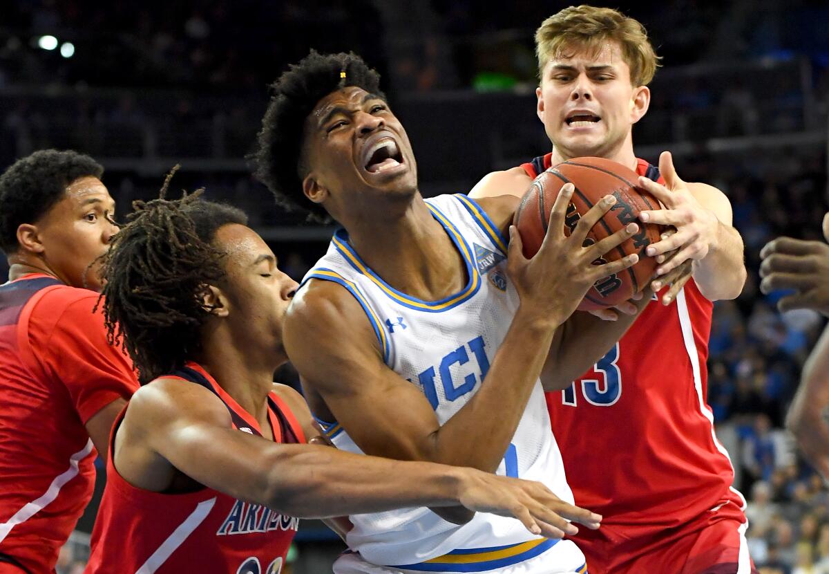 UCLA guard Chris Smith, center, is among the players who will be deciding soon whether he'll declare for the NBA draft or return for his senior season.