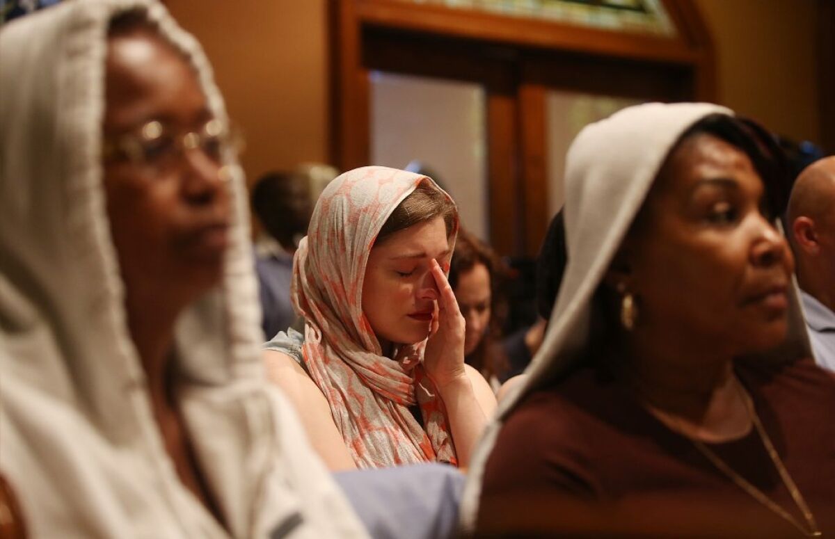 People sit during services honoring Trayvon Martin at Middle Collegiate Church in New York City.