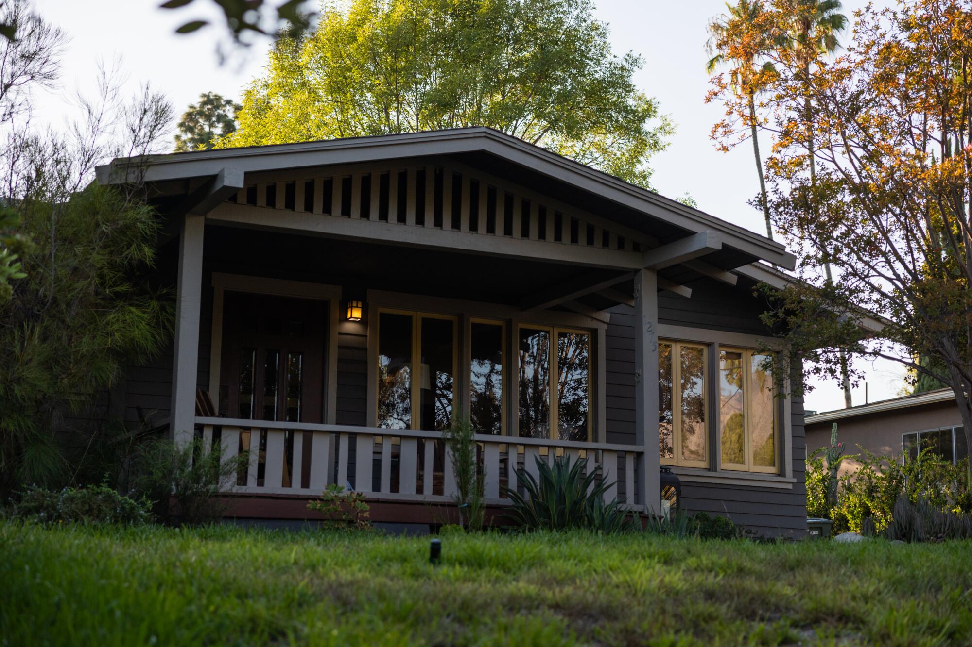 A brown Craftsman with overhanging eaves and a large front porch.