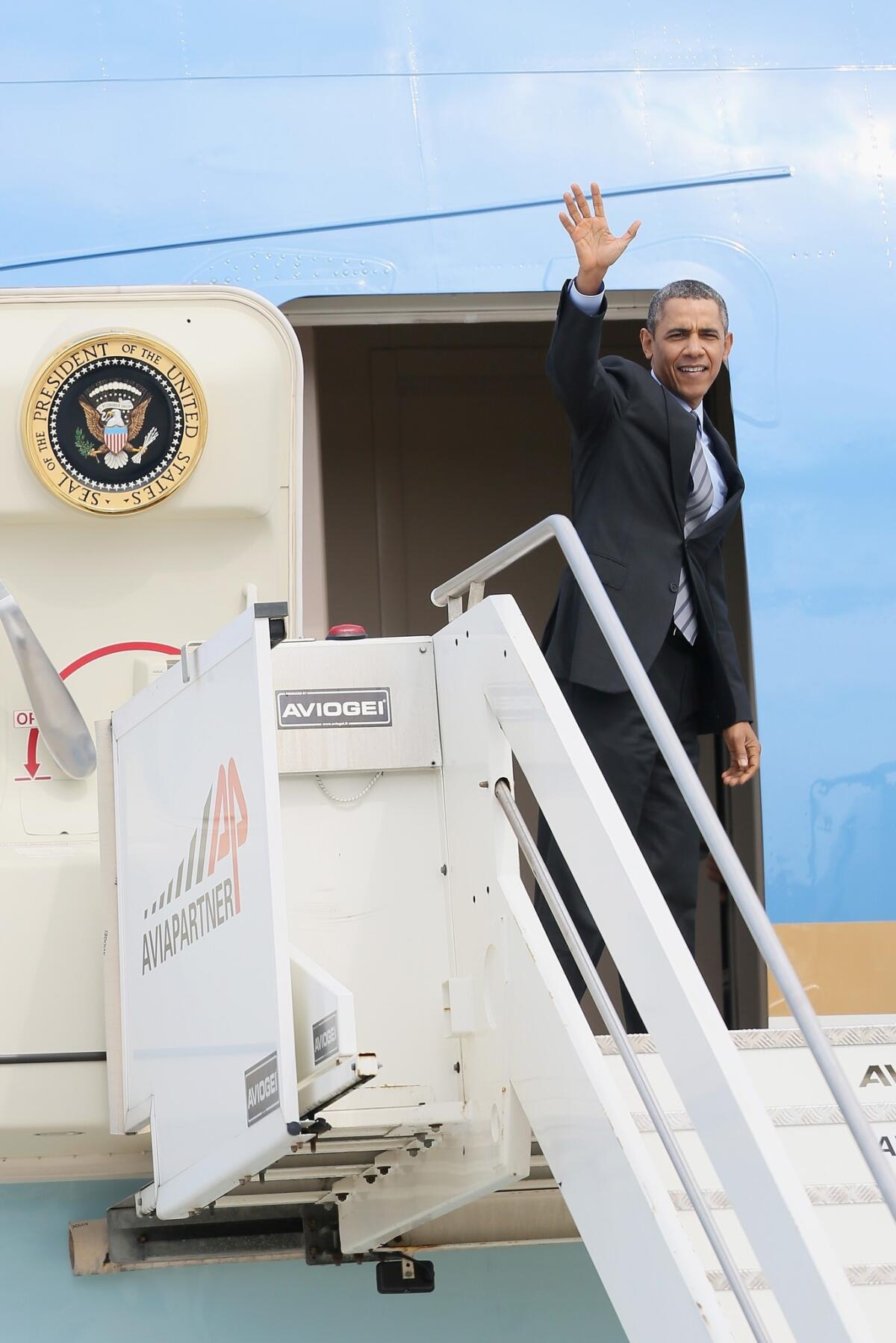 President Obama waves from Air Force One as he leaves Rome for Saudi Arabia.