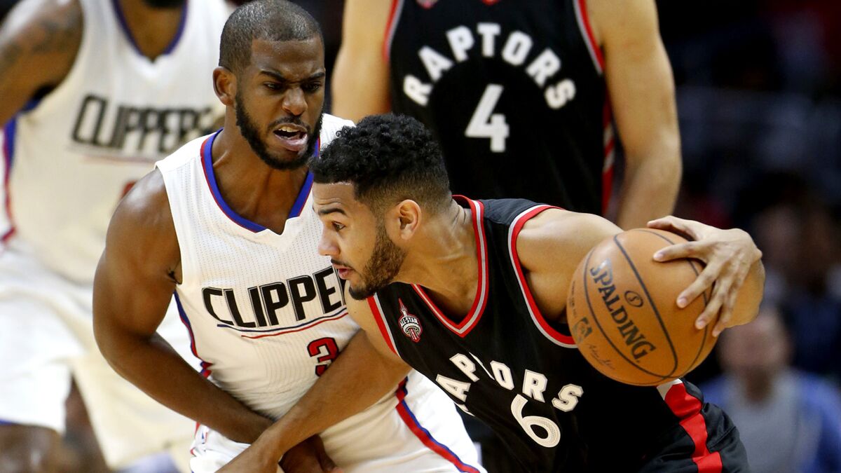 Clippers point guard Chris Paul tries to cut off a drive by Raptors guard Corey Joseph during the first half.