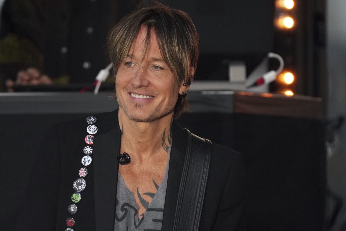 Keith Urban smiles as he performs on a morning TV show