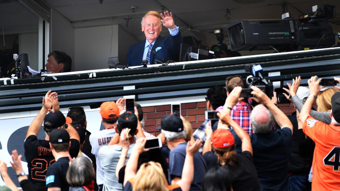 Dodgers broadcast announcer Vin Scully waves to the crowd while being honored at AT&T Park.