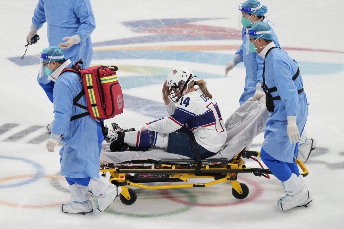 U.S. forward Brianna Decker is taken off the ice on stretcher after suffering an injury against Finland on Thursday.