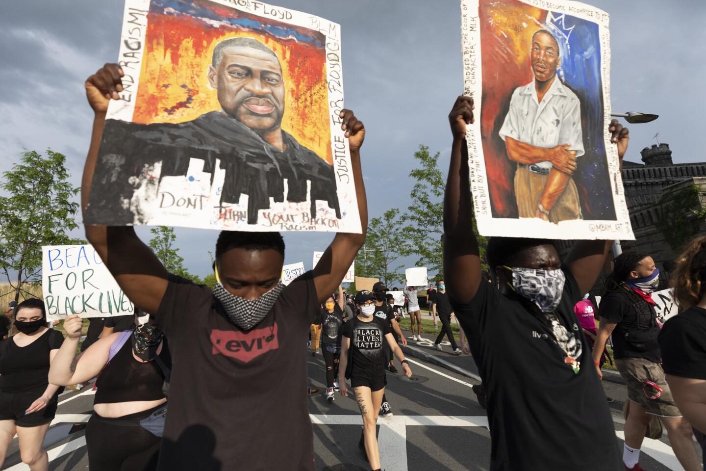 Demonstrators march during a protest in Boston against police brutality, Saturday.