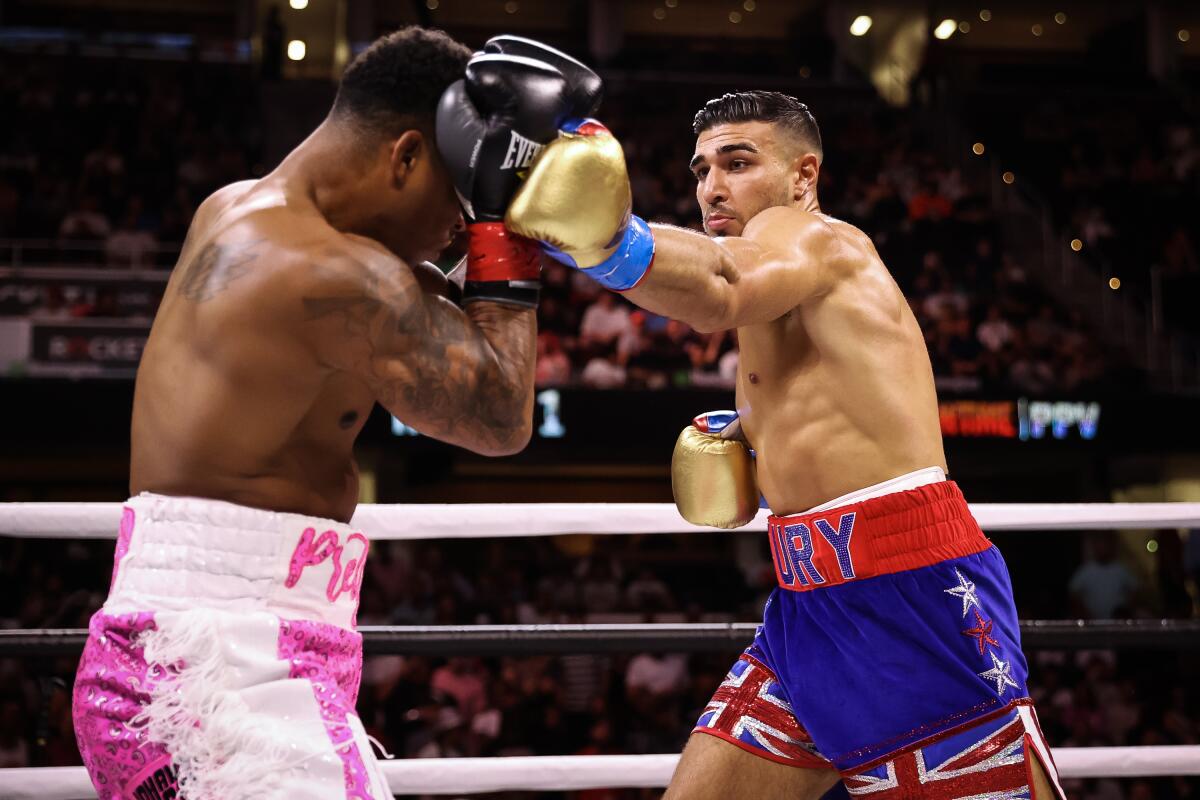 Tommy Fury, right, punches Anthony Taylor during their boxing match in Cleveland on Sunday.
