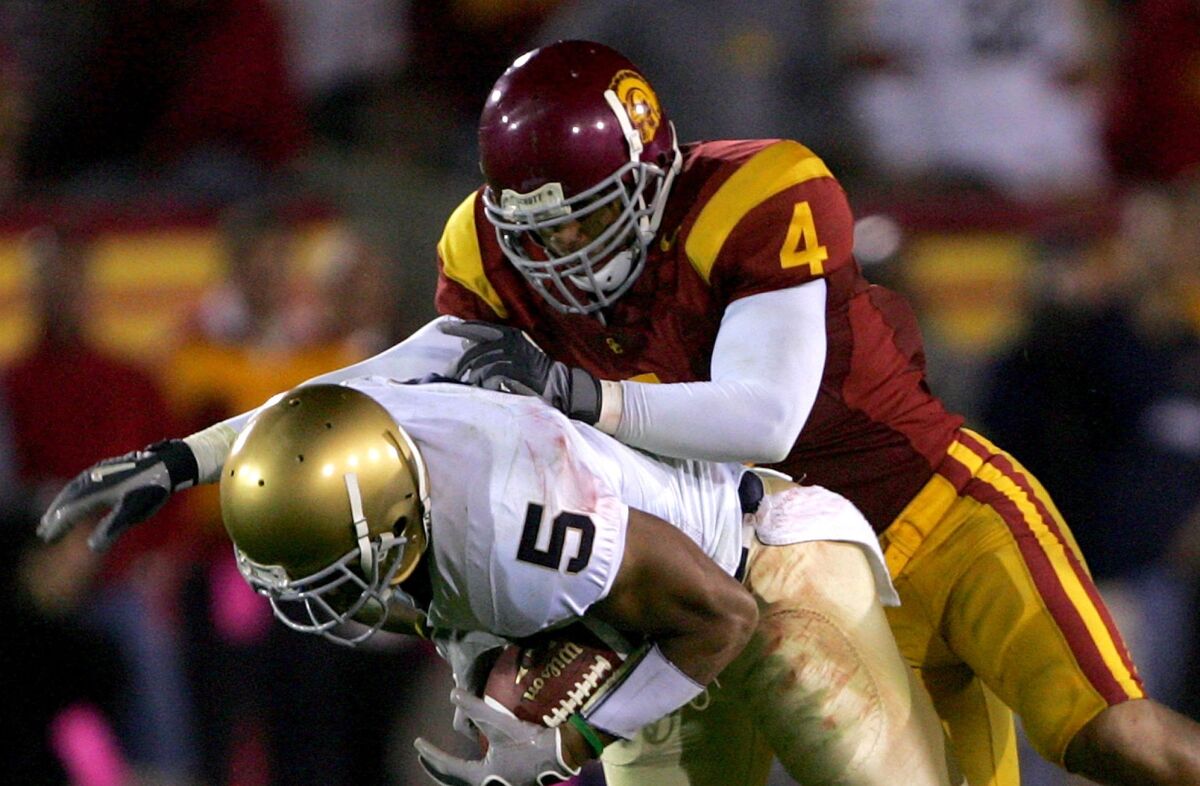 USC safety Kevin Ellison tackles Notre Dame receiver Rhema McKnight on Nov. 25, 2006, at the Coliseum. 