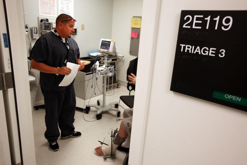 Vander Brug, Brian  B582191484Z.1 SYLMAR, CA  June 28 2012: Nurse Damien Pulido talks with a patient in the emergency room at Olive ViewUCLA Medical Center June 26 2012 in Sylmar.(Brian van der Brug/Los Angeles Times)