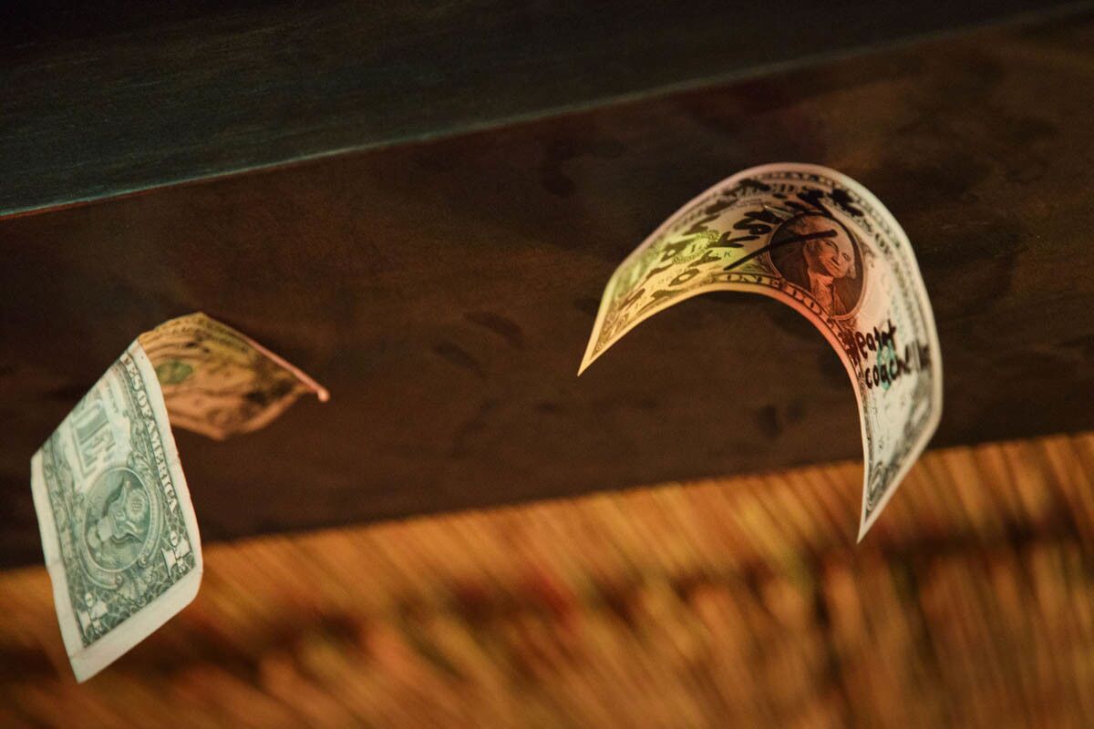 Dollar bills are stapled to the ceiling as tiki themed cocktails are served inside of the secret tiki bar PDTiki during weekend one of the three-day Coachella Valley Music and Arts Festival at the Empire Polo Grounds on Saturday, April 15, 2017 in Indio, Calif. Goldenvoice food and beverage director Nic Adler teamed with the bartenders at PDT (Please Don't Tell) in Manhattan, New York, to open a 35-person bar in the general admission area. An assortment of restaurants and chefs are providing unique food and crafted drink options for the festival. (Patrick T. Fallon/ For The Los Angeles Times)