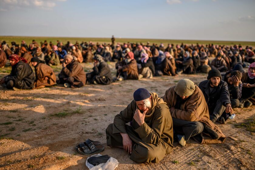 (FILES) In this file photo taken on February 22, 2019, men suspected of being Islamic State (IS) fighters wait to be searched by members of the Kurdish-led Syrian Democratic Forces (SDF) after leaving the IS group's last holdout of Baghouz, in Syria's northern Deir Ezzor province. - The Islamic State group may have lost its "caliphate", but three months later, experts have warned the jihadists are still attacking fighters and fields in Syria to show they remain relevant. (Photo by Bulent KILIC / AFP)BULENT KILIC/AFP/Getty Images ** OUTS - ELSENT, FPG, CM - OUTS * NM, PH, VA if sourced by CT, LA or MoD **