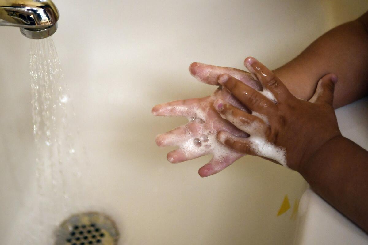 A child washes her hands.