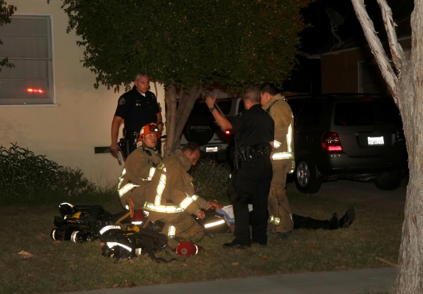 Glendale public safety officials help the injured pilot.