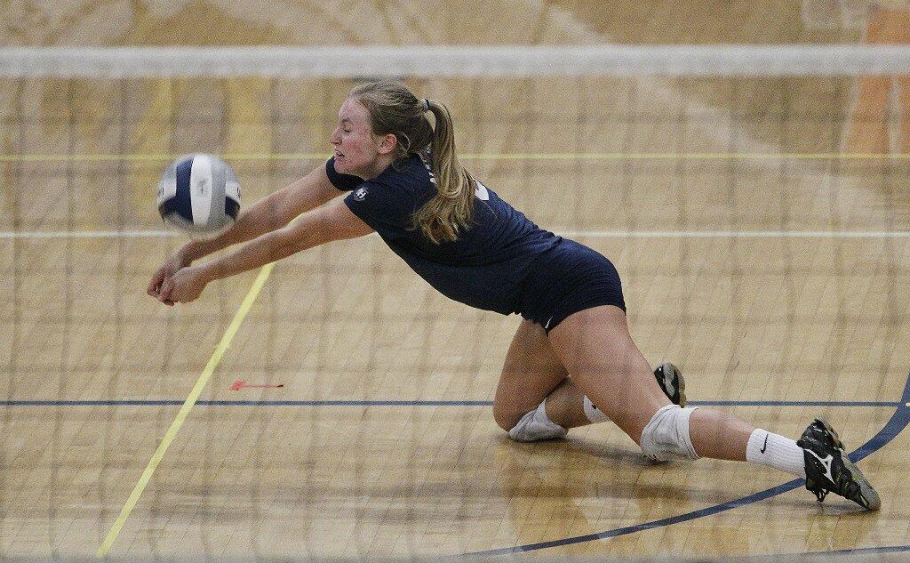 Newport Harbor High's Sammie Yeager digs a ball during the Battle of the Bay girls' volleyball match on Saturday.
