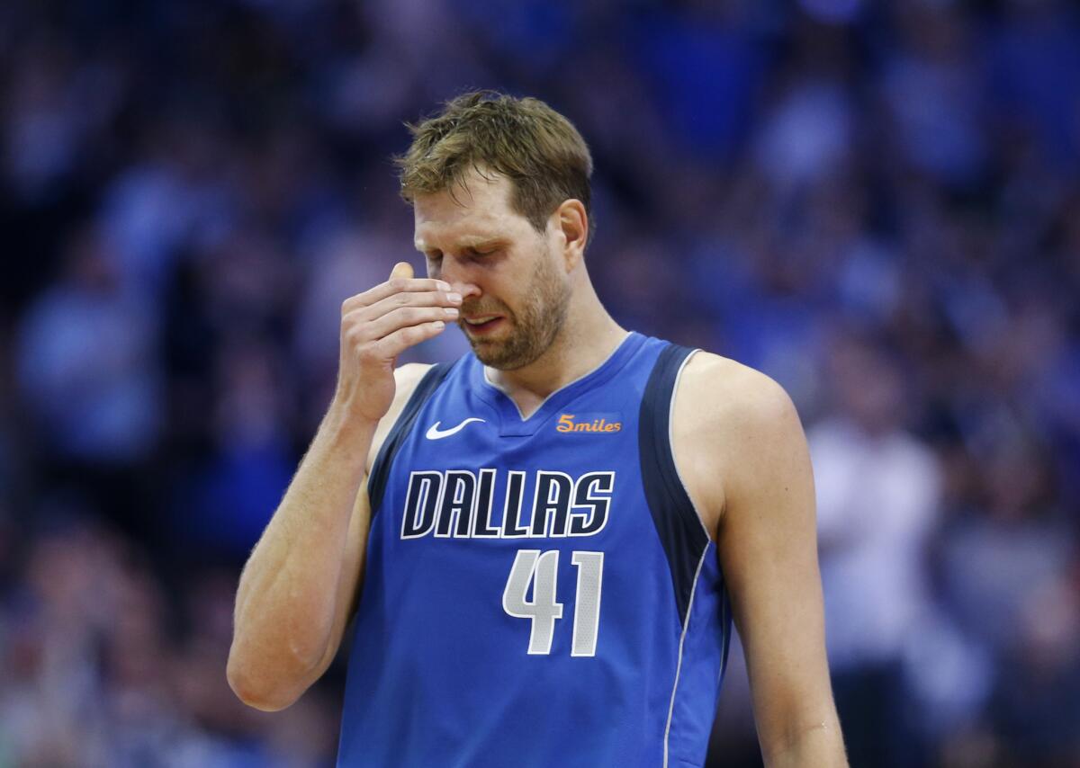 Mavericks forward Dirk Nowitzki gets emotional after a video played during a break in the first half.