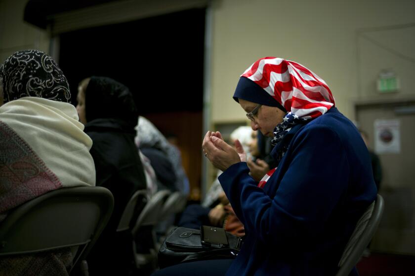 Jeelanne Gouda of Rancho Cucamonga prays during a vigil and prayer service for the victims of Wednesday's shooting rampage at the Chino Valley Islamic Center on Friday.