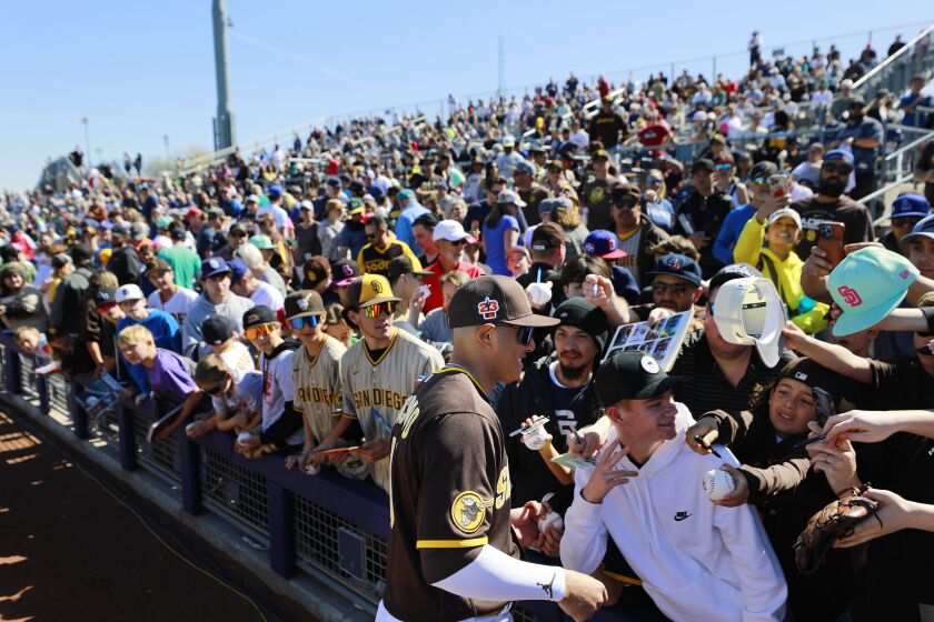 Peoria AZ - February 24: San Diego Padres' Manny Machado signs autographs before a spring training game against the Seattle Mariners on Friday, February 24, 2023 in Peoria, AZ. (K.C. Alfred / The San Diego Union-Tribune)