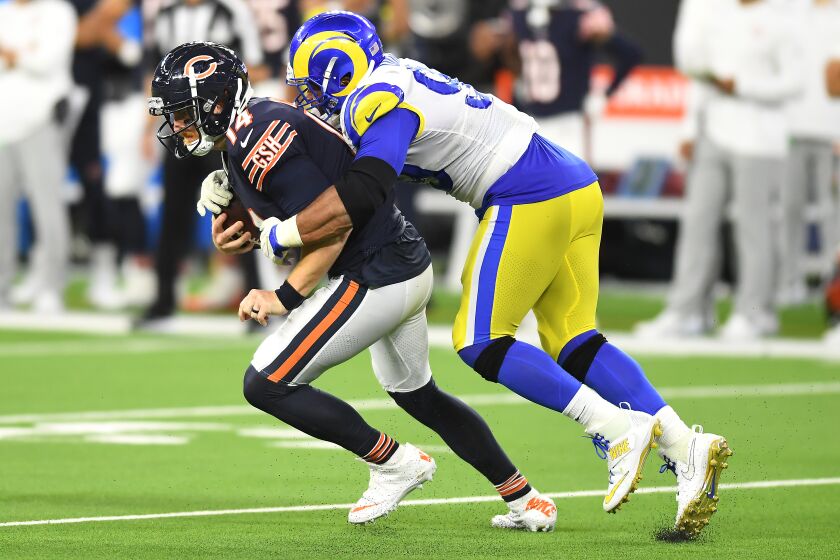 Inglewood, CA. September 12, 2021: Rams defensive lineman Aaron Donald sacks Bears quarterback Andy Dalton in the 4th quarter at SoFi Stadium in Inglewood Sunday. (Wally Skalij/Los Angeles Times)