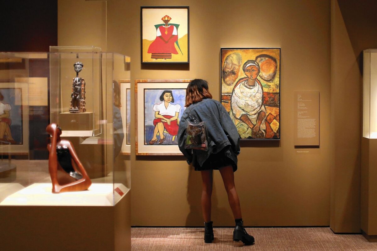 A visitor pauses while looking at the "Conversations: African and African American Artworks in Dialogue" exhibit at the Smithsonian Museum of African Art on the National Mall on July 15, 2015 in Washington, DC.