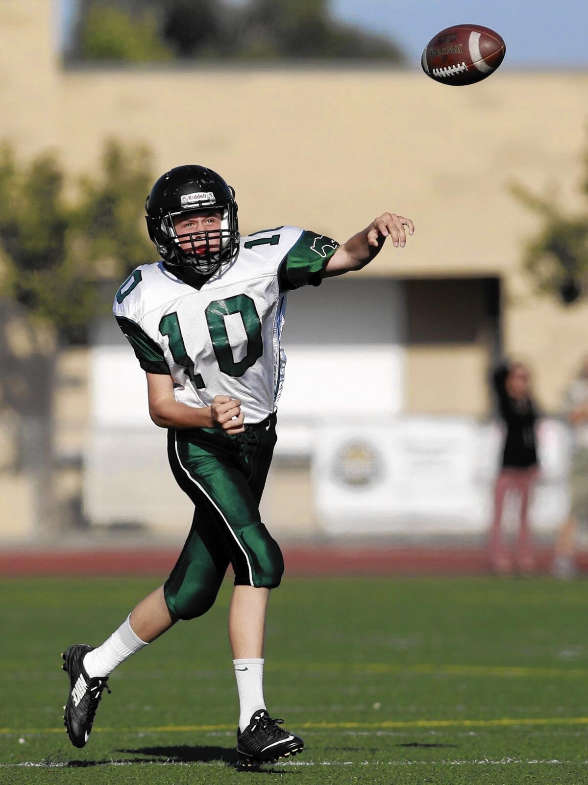 COSTA MESA, CA, October 16, 2014 -- Costa Mesa High quarterback Ben Swanson completes a pass during the second half against Estancia in a freshman Battle for the Bell game on Thursday. (Kevin Chang/ Daily Pilot)