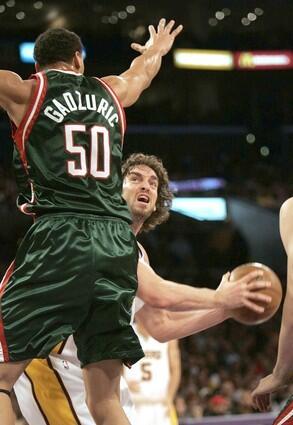 Lakers forward Pau Gasol waits for Bucks center Dan Gadzuric to land before attempting a shot during the first half Sunday.