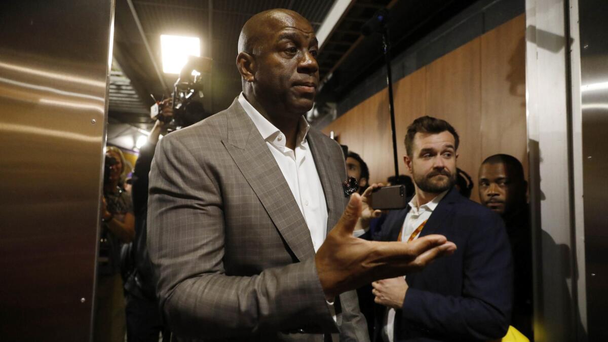 Magic Johnson walks down a hallway at Staples Center on April 9, the day he announced he was stepping down as Lakers president of basketball operation.