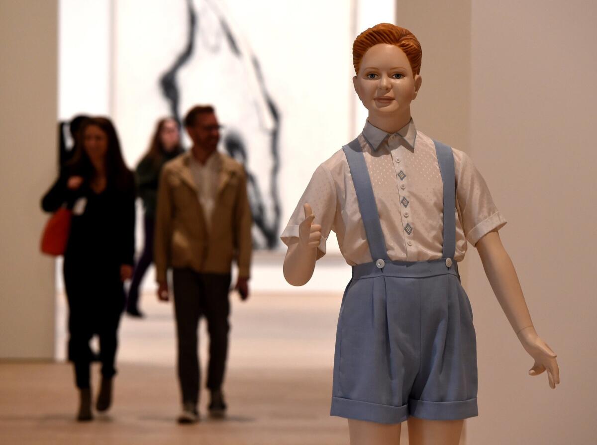 The Whitney Museum of American Art opens its new building to the public this week. "Boy," by sculptor Charles Ray, looks on as members of the media get a preview tour of the museum in advance of its opening