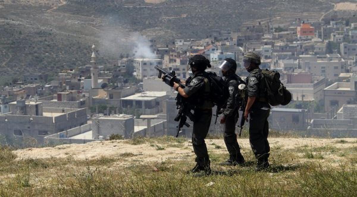 Israeli border police fire tear gas at Palestinian villagers during clashes with Jewish settlers near the West Bank city of Nablus.