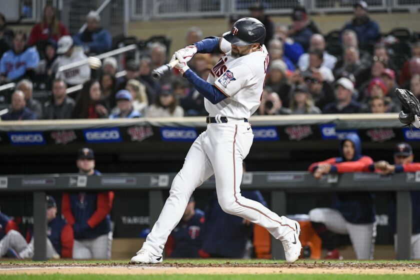 Minnesota Twins' Jake Cave hits an RBI single off Chicago White Sox pitcher Johnny Cueto during the second inning of a baseball game Wednesday, Sept. 28, 2022, in Minneapolis. (AP Photo/Craig Lassig)