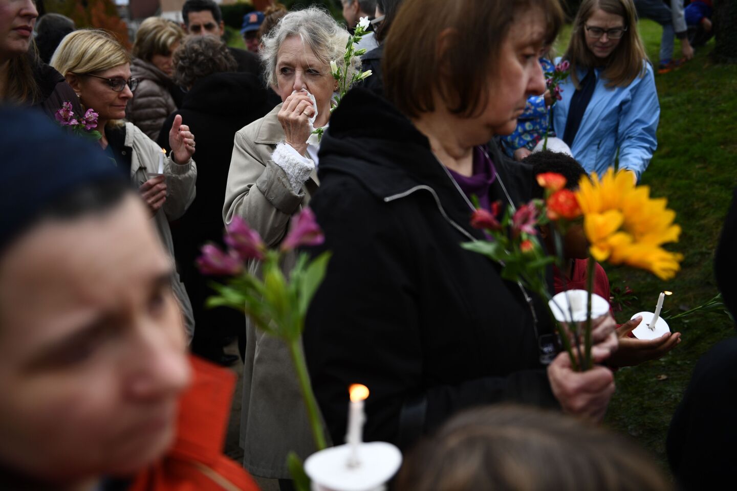 People arrive to pay respects at a memorial outside the Tree of Life synagogue on Oct. 28, 2018, after a shooting there the previous day left 11 people dead in the Squirrel Hill neighborhood of Pittsburgh.