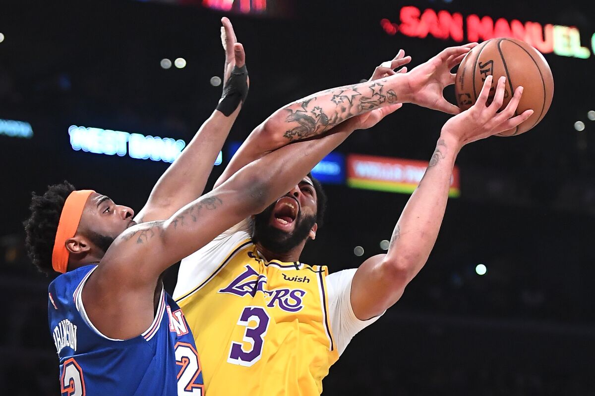 Lakers Anthony Davis is fouled by New York Knicks Mitchell Robinson in the first quarter at the Staples Center on Jan. 7.