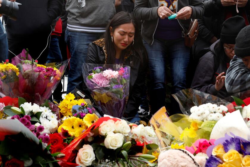 Fans gathered near a memorial for Kobe Bryant at Staples Center in downtown Los Angeles.