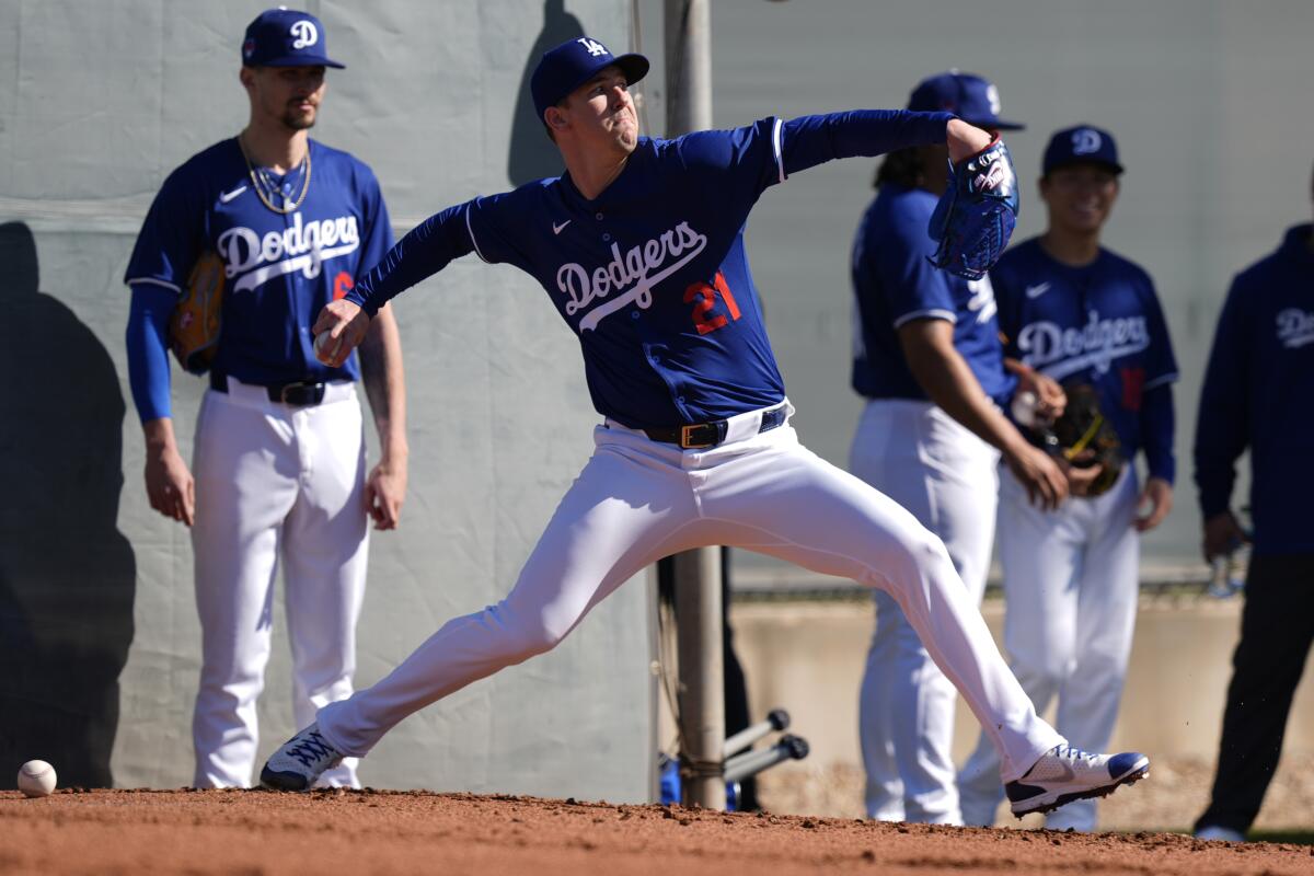 Dodgers pitcher Walker Buehler throws during the first day of spring training at Camelback Ranch.