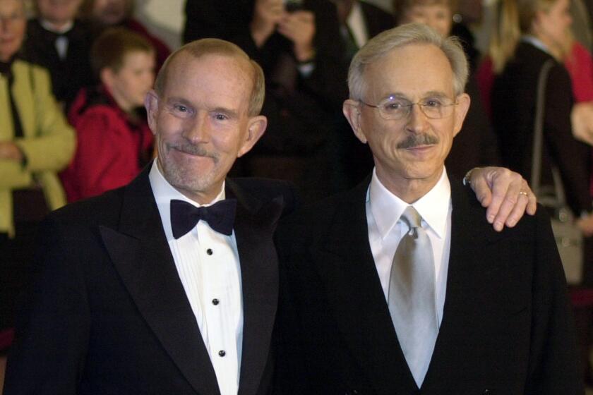 FILE - This Oct. 29, 2002 file photo shows The Smothers Brothers, Tom Smothers, left, and Dick Smothers at the Kennedy Center in Washington for the Mark Twain Prize for Humor Award ceremony honoring Bob Newhart. The duo has stepped out of retirement to commemorate the day 50 years ago when CBS canceled their show over their political impudence. The pair reunited Monday, July 29, 2019, for several appearances at the National Comedy Center in Jamestown, New York. (AP Photo/Lawrence Jackson, File)